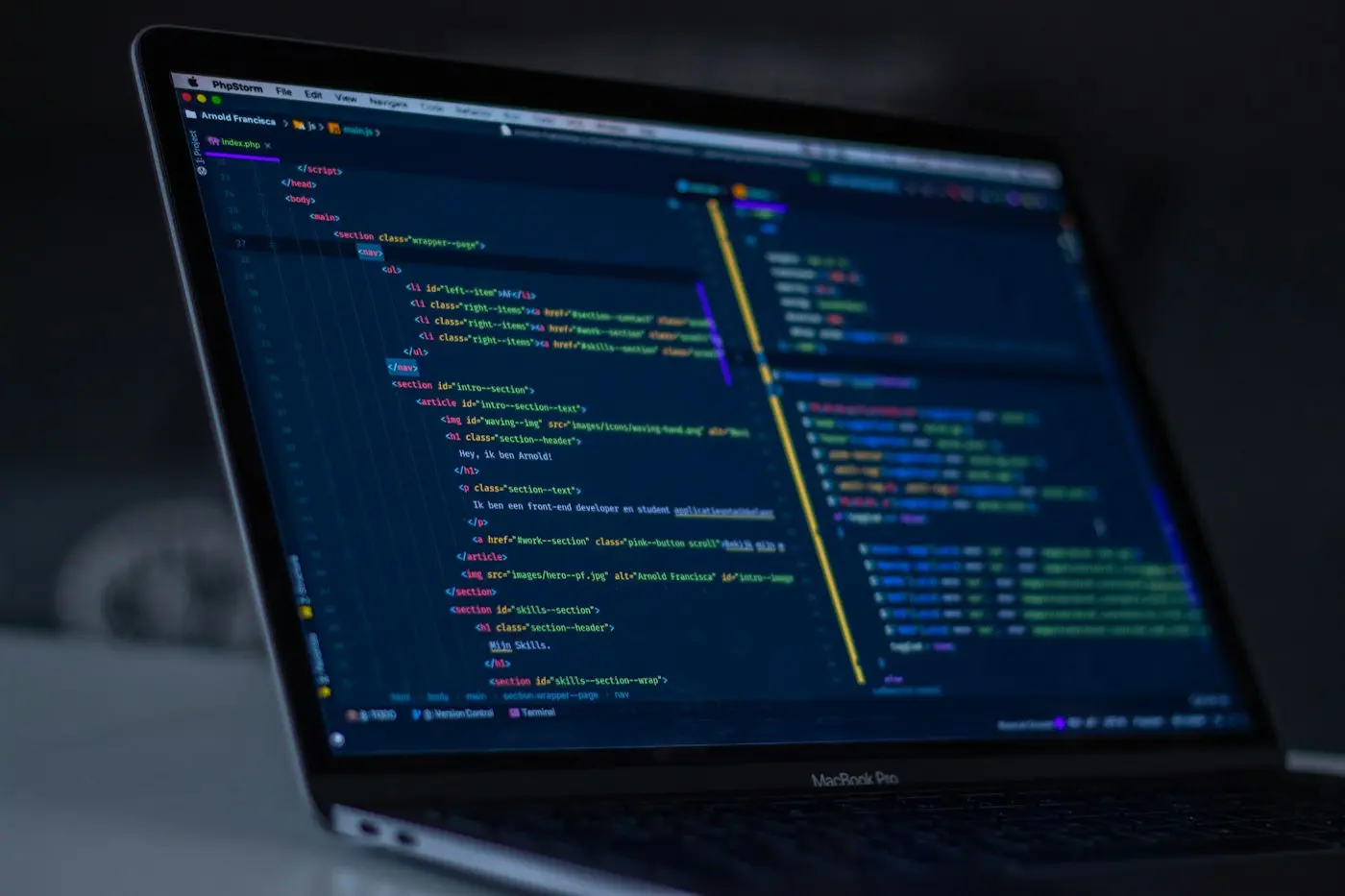 Code on a laptop screen in a dim room.