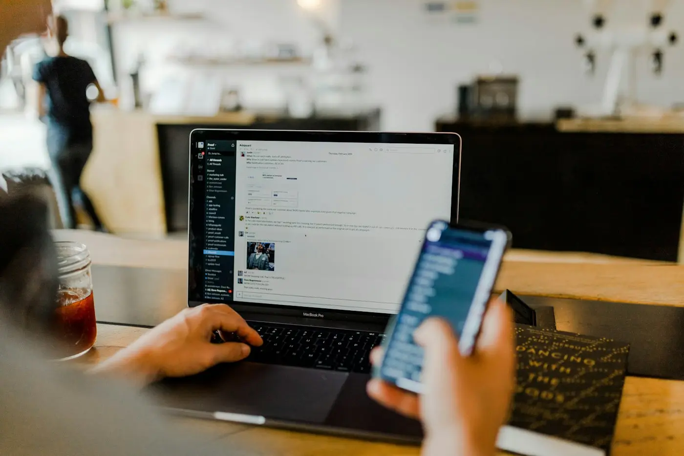 Checking a product on a phone and a laptop side by side.